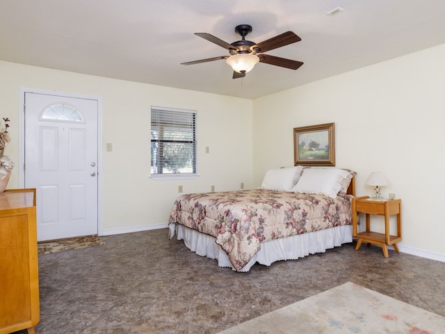 bedroom with ceiling fan and dark tile patterned floors