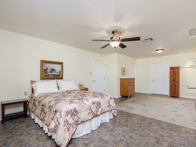 bedroom with a textured ceiling and ceiling fan