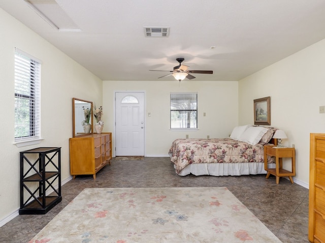 bedroom featuring multiple windows and ceiling fan