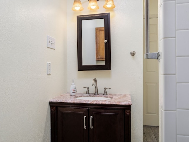 bathroom with vanity and hardwood / wood-style flooring