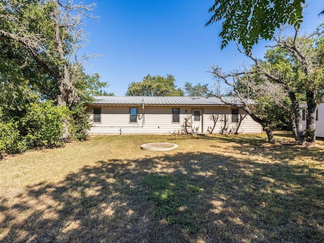 rear view of house featuring a yard