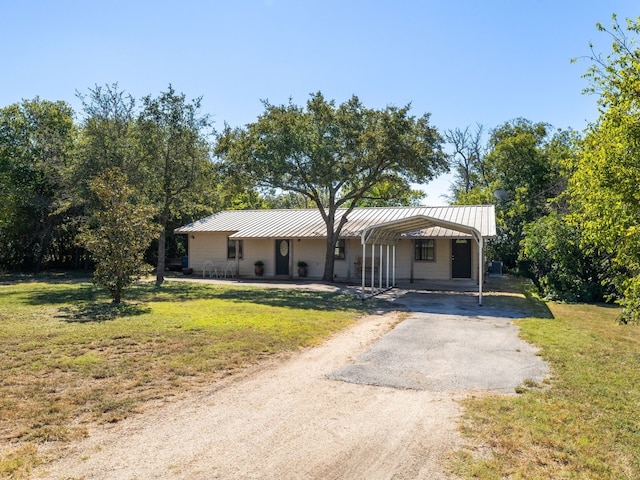 single story home featuring a carport and a front yard