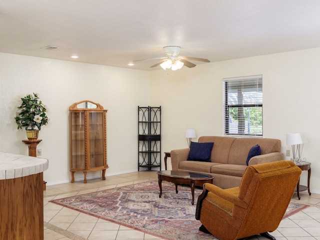 tiled living room with ceiling fan