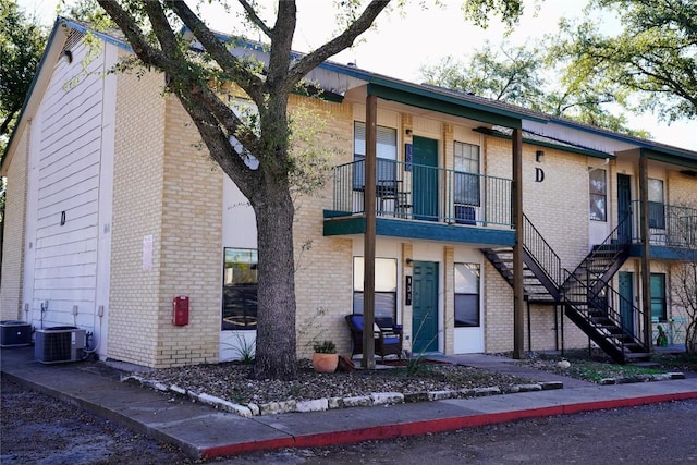 view of front facade with central AC and a balcony