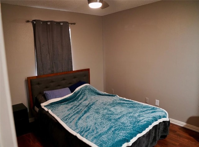 bedroom featuring ceiling fan and dark hardwood / wood-style flooring