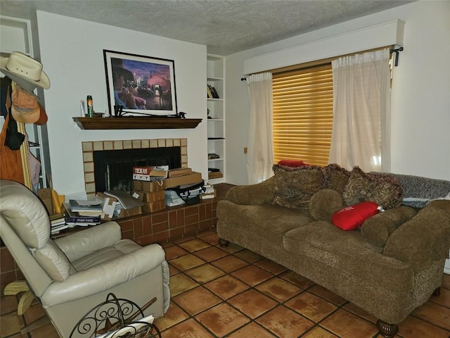 505 W 7th St Unit 108, Austin, TX 78701 - living area with built in shelves, a tiled fireplace, and a textured ceiling