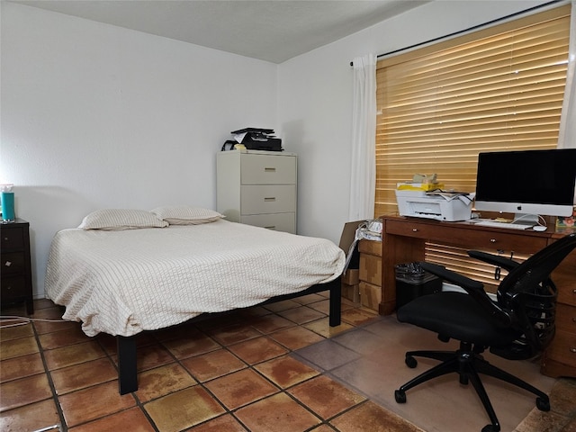 bedroom with dark tile patterned flooring