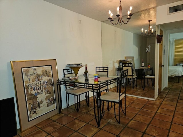 505 W 7th St Unit 108, Austin, TX 78701 - dining room with a chandelier, a textured ceiling, and tile patterned flooring