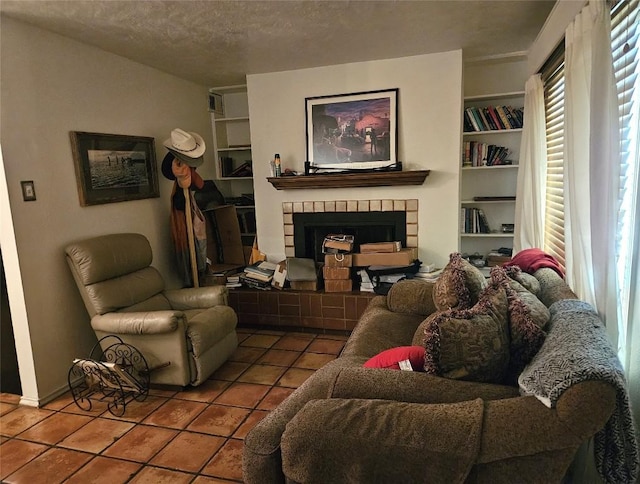 505 W 7th St Unit 108, Austin, TX 78701 - tiled living room featuring a tile fireplace, built in features, and a textured ceiling