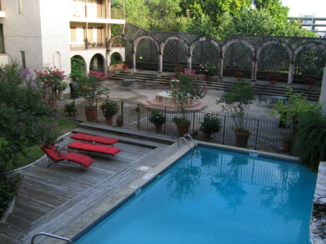 view of pool featuring a wooden deck and a patio