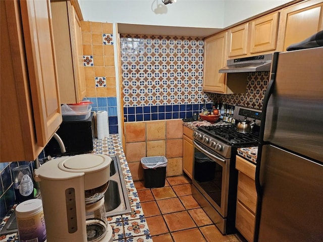 505 W 7th St Unit 108, Austin, TX 78701 - kitchen featuring stainless steel appliances, under cabinet range hood, light brown cabinetry, light tile patterned floors, and decorative backsplash