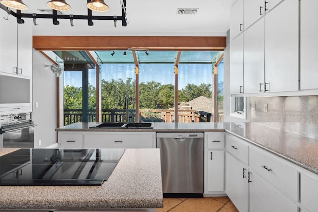 kitchen with white cabinets, sink, black appliances, and decorative backsplash