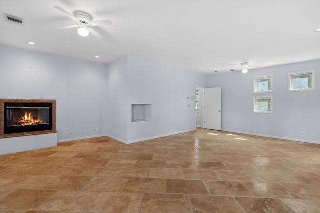 unfurnished living room featuring ceiling fan