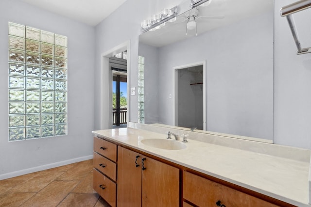 bathroom with ceiling fan and vanity