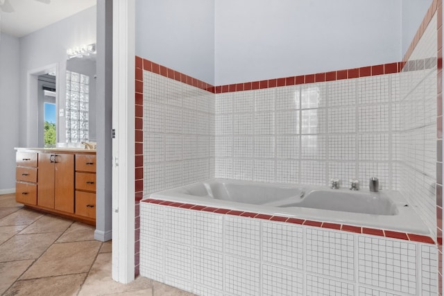 bathroom featuring vanity and a relaxing tiled tub