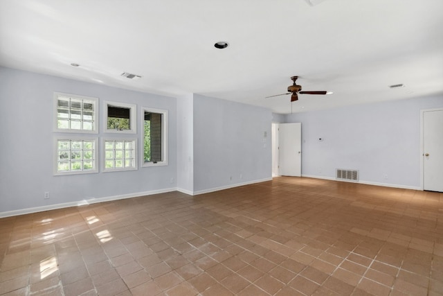 spare room featuring tile patterned floors and ceiling fan