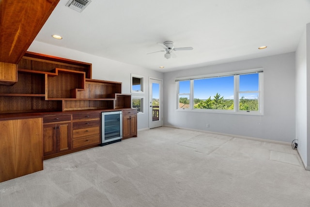 kitchen featuring light carpet, ceiling fan, and beverage cooler