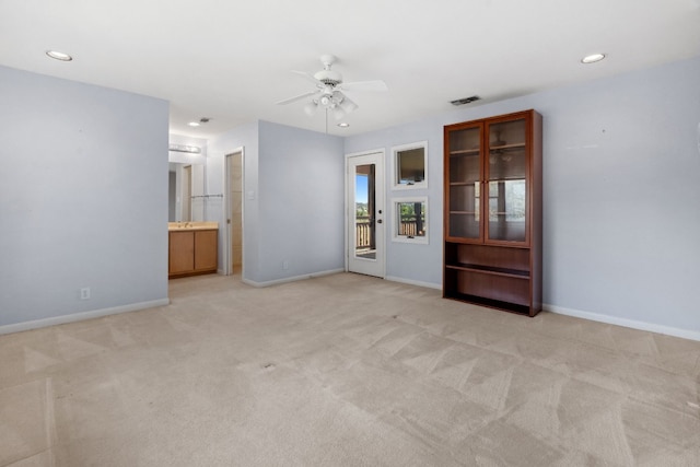 empty room with light colored carpet and ceiling fan