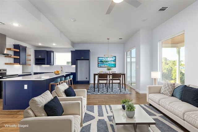 living room featuring hardwood / wood-style flooring and ceiling fan