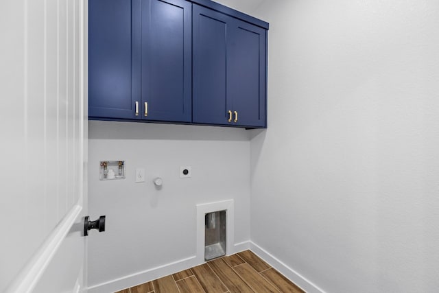 laundry area featuring electric dryer hookup, cabinets, gas dryer hookup, washer hookup, and dark hardwood / wood-style floors