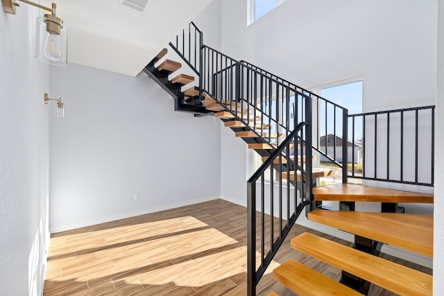 stairs featuring hardwood / wood-style floors