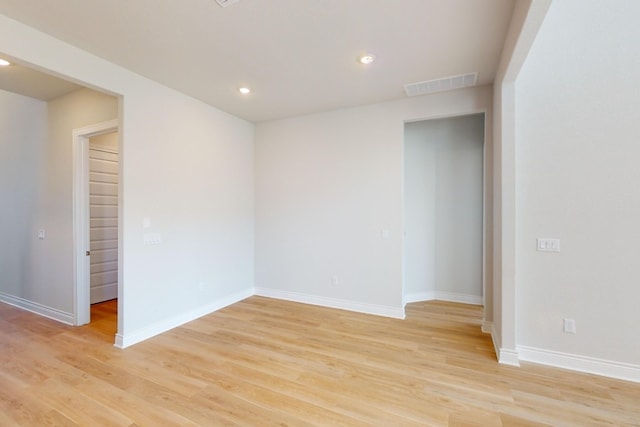 unfurnished room with light hardwood / wood-style floors