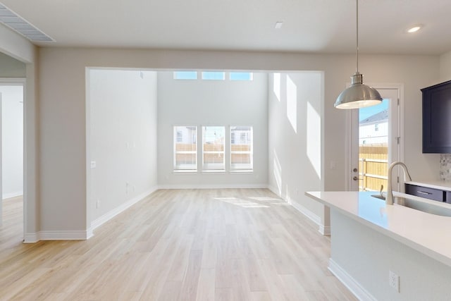 interior space featuring a wealth of natural light, sink, and light wood-type flooring