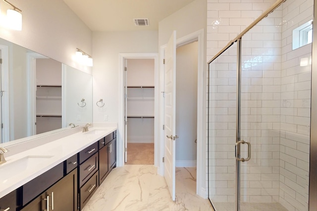 bathroom with vanity and a shower with shower door