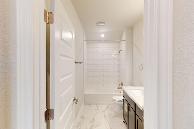 full bathroom featuring vanity, toilet, and tiled shower / bath combo