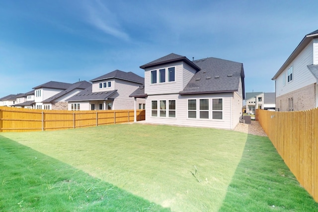 rear view of house with a lawn