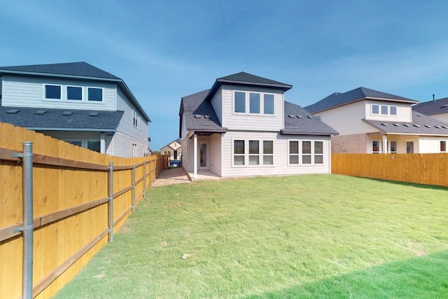 rear view of house with a lawn