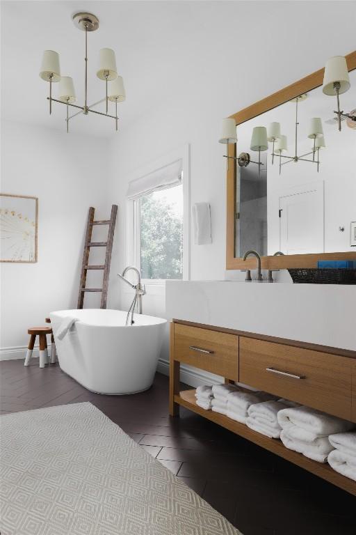 11505 SW Oaks, Austin, TX 78737 - full bath featuring vanity, a freestanding tub, and a chandelier
