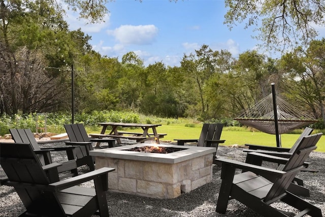 11505 SW Oaks, Austin, TX 78737 - view of patio featuring an outdoor fire pit and a wooded view