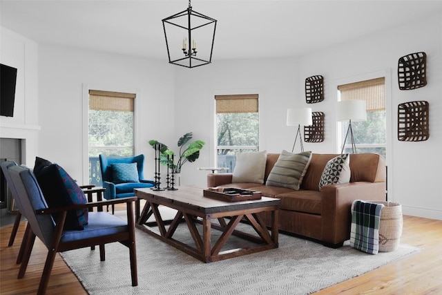 11505 SW Oaks, Austin, TX 78737 - living area with plenty of natural light, wood finished floors, and a chandelier