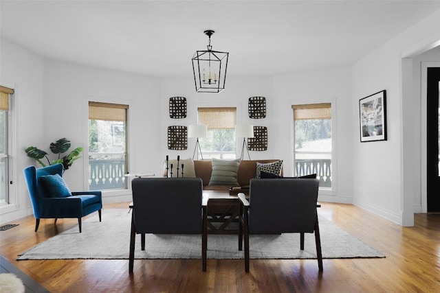 11505 SW Oaks, Austin, TX 78737 - dining area with healthy amount of natural light, wood finished floors, baseboards, and a chandelier