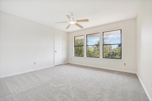 spare room featuring carpet flooring and ceiling fan