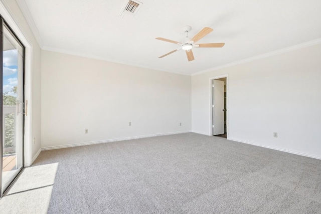 carpeted spare room featuring ceiling fan and crown molding