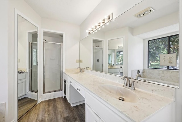 bathroom featuring hardwood / wood-style floors, vanity, and separate shower and tub