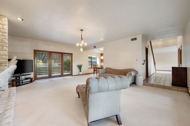 carpeted living room featuring a chandelier