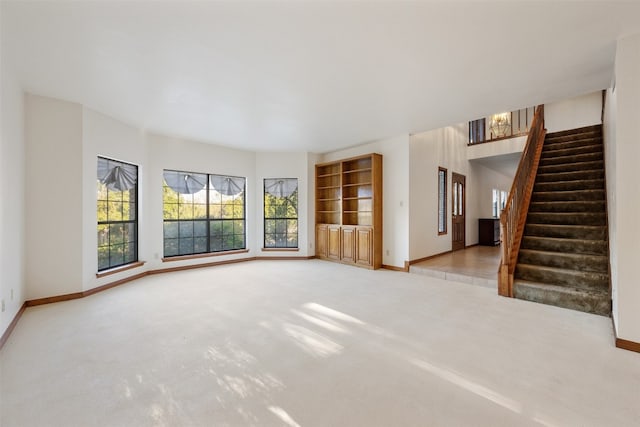 unfurnished living room featuring light colored carpet