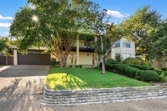 view of front of home with a front lawn and a garage