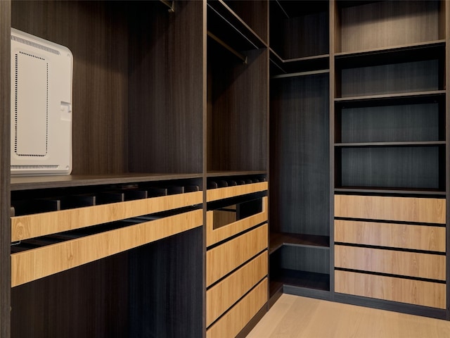 spacious closet featuring light hardwood / wood-style floors