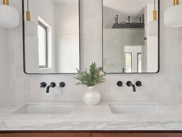 bathroom featuring vanity, a healthy amount of sunlight, and walk in shower