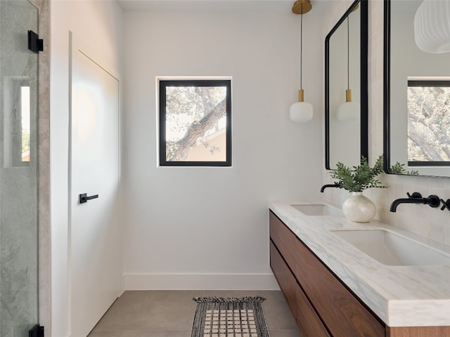 bathroom with tile patterned flooring, vanity, and an enclosed shower