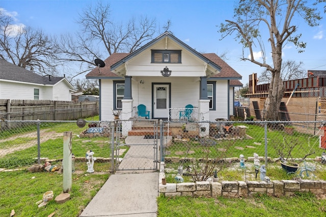 bungalow with a front yard and a porch