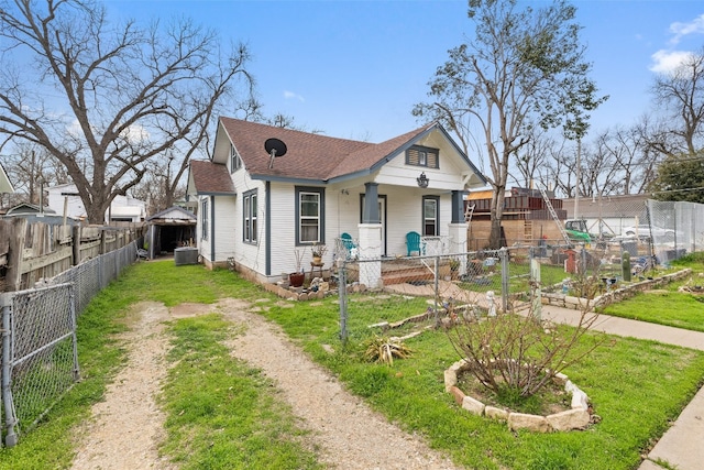 bungalow-style home featuring a front yard and central AC