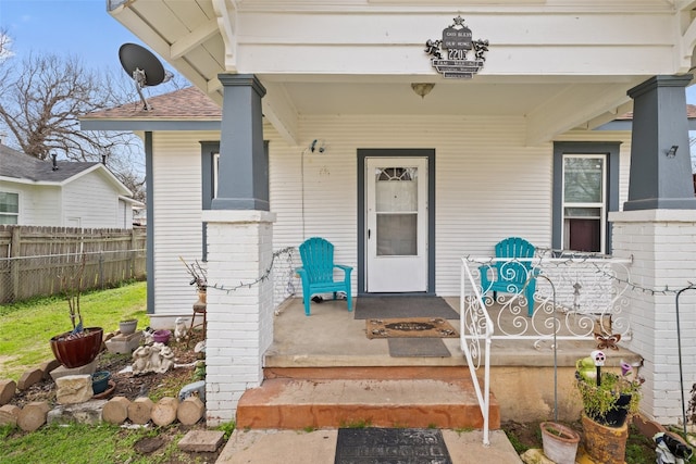 view of exterior entry with covered porch