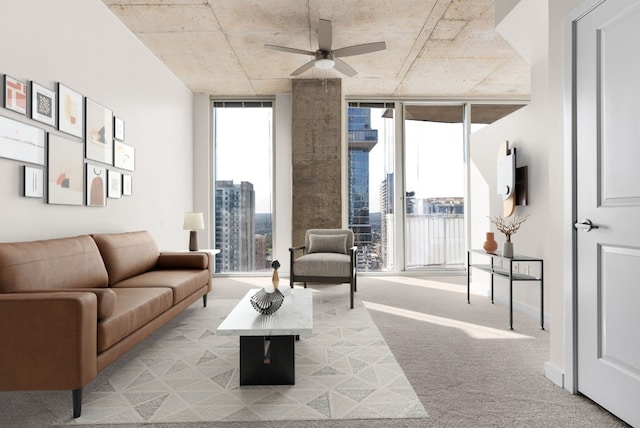 carpeted living room with a wall of windows and ceiling fan