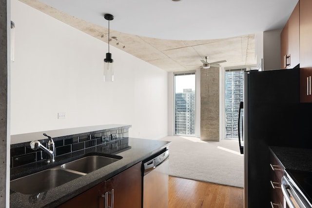 kitchen featuring pendant lighting, sink, light hardwood / wood-style flooring, ceiling fan, and stainless steel appliances