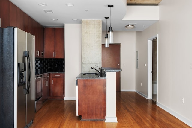 kitchen featuring sink, decorative light fixtures, stainless steel fridge with ice dispenser, dark hardwood / wood-style flooring, and decorative backsplash